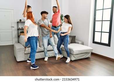 Group Of Young Friends Smiling Happy And Dancing At Home.