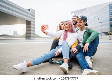 Group of young friends taking a selfie in the city - Happy millennials sharing content on social media - People, technology and lifestyle. - Powered by Shutterstock