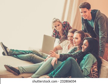 Group Of Young Friends Taking Selfie In Home Interior 