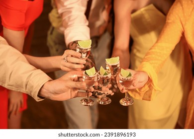 Group of young friends with tequila shots in bar at night, closeup - Powered by Shutterstock