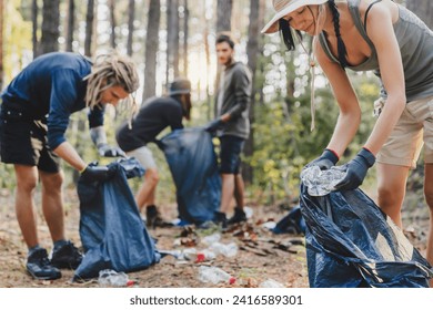 Group of young friends volunteers with trash bags in forest, helping to clean forest from litter. Earth day, eco-tourism concept - Powered by Shutterstock