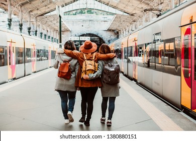 A group of young friends waiting relaxed and carefree at the station in Porto, Portugal before catching a train. Travel photography. Lifestyle.