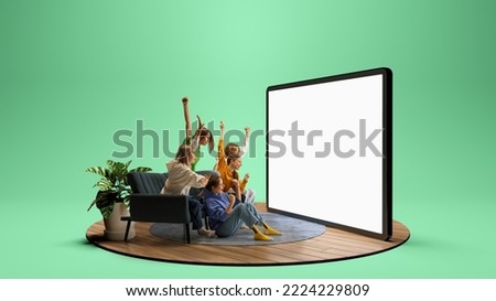 Group of young friends watching football match, sport show or movie together. Excited girls and boys sitting in front of huge 3D model of empty tv screen at home interior. Emotions, sport, sales