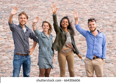 Group Of Young Friends Waving Their Hands As A Gesture Of Saying Goodbye Concept 