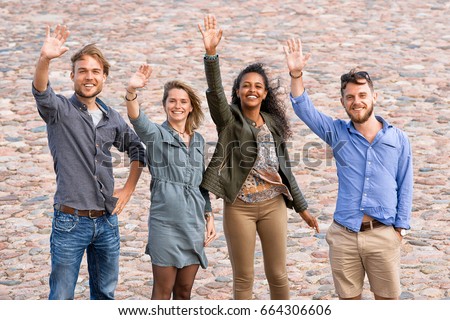 Group of young friends waving their hands as a gesture of saying goodbye Concept 
