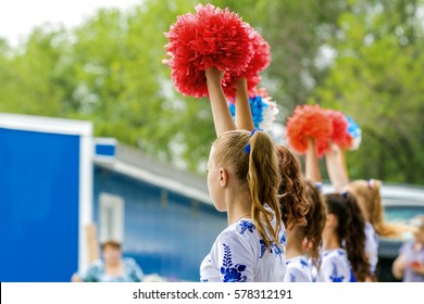 Group Of Young Girls Cheerleader With Red Pom-poms