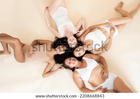 group of young girls of different sizes and races. Smiling together. Beautiful bodies. Natural beauty. Self-love.