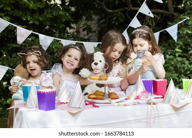 Group of young girls dressed up at a garden party. - Powered by Shutterstock