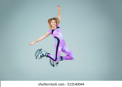 The group of young girls, jumping on kangoo training on gray