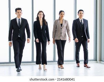 Group of young happy Asian male and female professional successful businessman and businesswoman colleagues partnership teamwork in formal business suit smiling walking side by side forward together. - Powered by Shutterstock