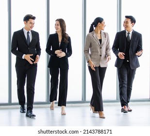 Group Of Young Happy Asian Male And Female Professional Successful Businessman And Businesswoman Colleagues Partnership Teamwork In Formal Business Suit Smiling Walking Side By Side Forward Together.