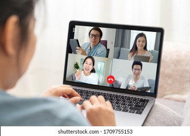 Group Of Young Happy Asian Work From Home Meeting Or Brainstorming Online Video Conference Application On 5G Internet With Covid Coronavirus Business Continuity Plan Via Tablet Or Notebook Computer.