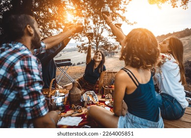 Group of young happy friends having pic-nic outdoors - People having fun and celebrating while grilling ata barbacue party in a countryside - Powered by Shutterstock