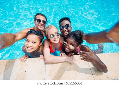 Group Of Young Happy Multiethnic People Taking Selfie In Swimming Pool 