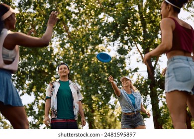 Group of young happy people playing with frisbee in nature.  - Powered by Shutterstock