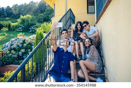 Similar – Happy young people walking along road in summer day