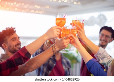 Group Of Young Happy People Toasting With Glasses Of Spritz (cocktails) - Rooftop Birthday Party With Best Friends Concept