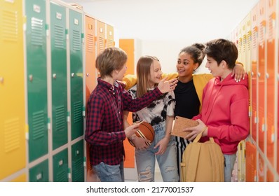 Group of young high school students standing near locker in campus hallway talking during break. - Powered by Shutterstock