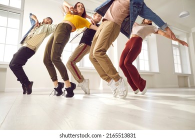 Group Of Young Hip Hop Dancers Rehearse Together And Learn New Choreography In Dance Studio. Talented Young People In Casual Clothes Who Are Standing On Their Toes Same Time. Concept Of Modern Dance