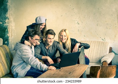 Group Of Young Hipster Best Friends With Computer Laptop In Urban Alternative Location - Concept Of Friendship And Fun With New Trends And Technology - Wireless Connection And Web Internet Interaction