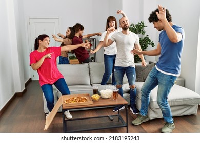 Group Of Young Hispanic Friends Having Party Dancing At Home.