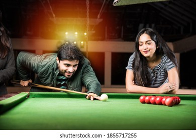 A Group Of Young Indian Asian Young People Or Friends Playing Fun Billiards, Snooker Or Pool