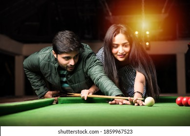 A Group Of Young Indian Asian Young People Or Friends Playing Fun Billiards, Snooker Or Pool