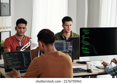 Group of young Indian devops engineers working in modern office, coding and maintaining updates - Shutterstock ID 2176735961