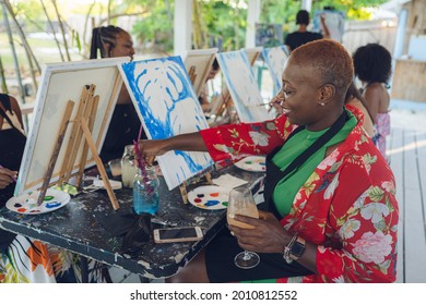 A Group Of Young Individuals Enjoying Paint N Sip Activities Outdoor. A Beginners Class For Painting. Nassau, Bahamas - May 29th, 2021