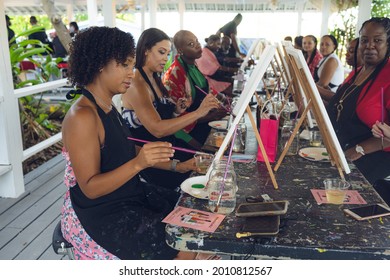 A Group Of Young Individuals Enjoying Paint N Sip Activities Outdoor. A Beginners Class For Painting. Nassau, Bahamas - May 29th, 2021