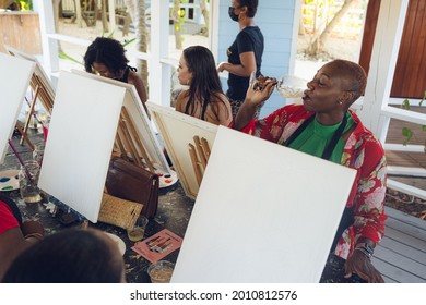 A Group Of Young Individuals Enjoying Paint N Sip Activities Outdoor. A Beginners Class For Painting. Nassau, Bahamas - May 29th, 2021