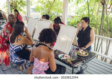 A Group Of Young Individuals Enjoying Paint N Sip Activities Outdoor. A Beginners Class For Painting. Nassau, Bahamas - May 29th, 2021