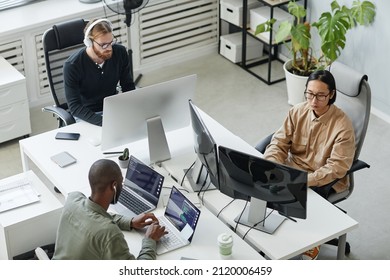 Group of young intercultural diversity programmers developing new programs in contemporary development bureau - Shutterstock ID 2120006459