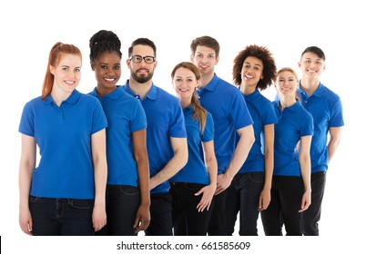 Group Of Young Janitors Standing In Row Against White Background