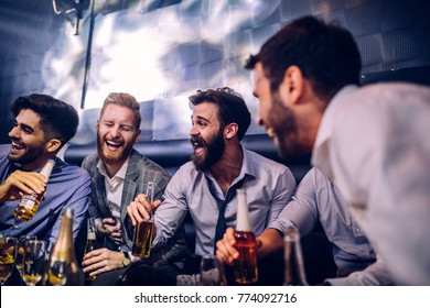Group Of Young Men Drinking At A Nightclub