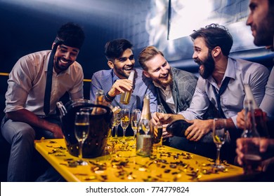 Group Of Young Men Drinking At A Nightclub