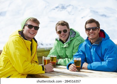 Group Of Young Men Enjoying Drink In Bar At Ski Resort - Powered by Shutterstock