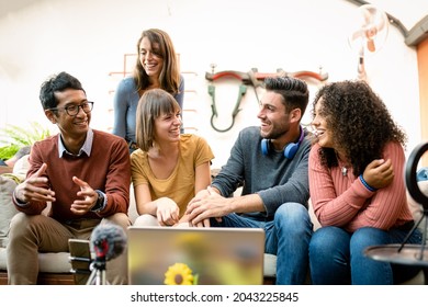 group of young millennials sharing contents and interview with webcam and laptop, influencers and vloggers having fun on live streaming, happy coworkers of a small business talking and planning