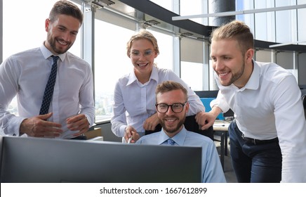 Group of young modern people in formalwear using modern technologies while working in the creative office - Shutterstock ID 1667612899
