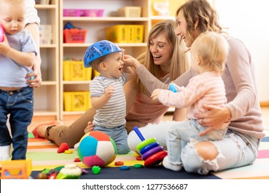 Group Of Young Moms With Their Babies At Playgroup