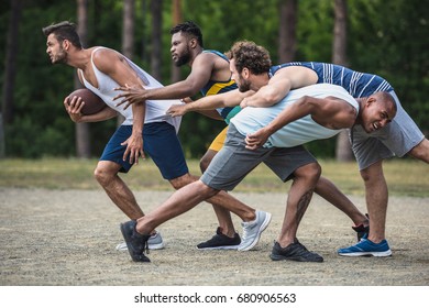 Group Of Young Multicultural Men Playing Football On Court