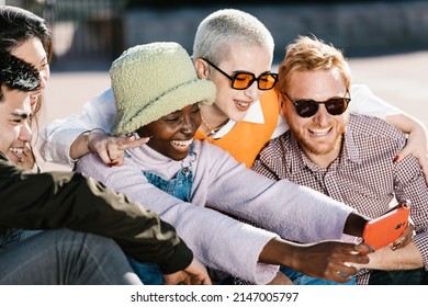 Group Of Young Multiracial Friends Taking A Selfie With A Mobile Phone Outdoors. Friendship, Youth Culture And Technology Concept.