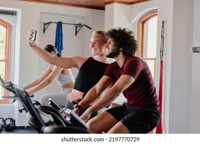 Group Of Young Multiracial Friends Taking Selfie With Mobile Phone At The Gym