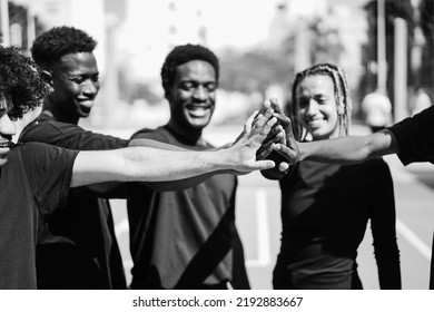 Group Of Young Multiracial People Stacking Hands Outdoor - Focus On Hands - Black And White Editing