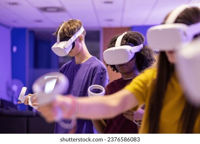 group of young multiracial people using virtual reality glasses - online game in metaverse - - Powered by Shutterstock