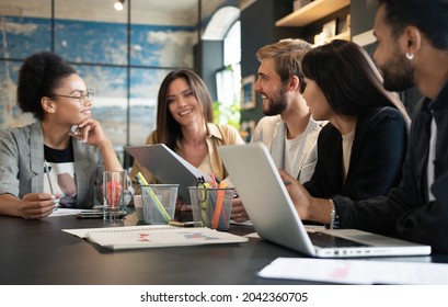 Group of young multiracial people working in modern office. Businessmen at work during meeting. - Shutterstock ID 2042360705