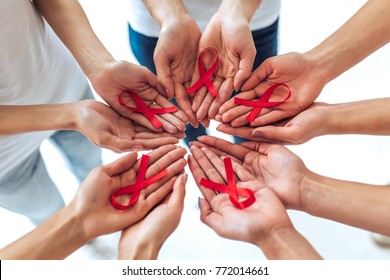 Group of young multiracial woman with red ribbons in hands are struggling against HIV/AIDS. AIDS awareness concept. - Powered by Shutterstock