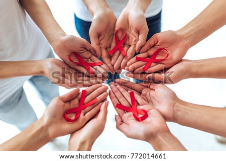 Group of young multiracial woman with red ribbons in hands are struggling against HIV/AIDS. AIDS awareness concept.