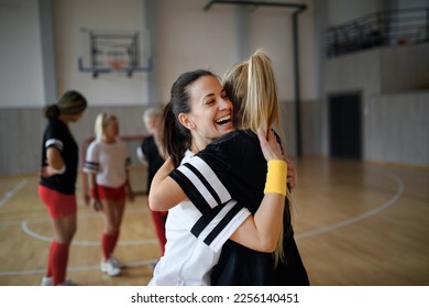 Group of young and old women, sports team players, in gym celebrating victory, hugging. - Powered by Shutterstock