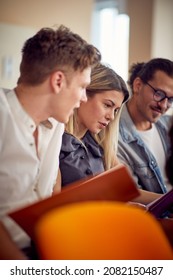 A Group Of Young Participants Is Reading Scripts During A Business Lecture In A Working Atmosphere In The Conference Room. Business, People, Meeting, Company